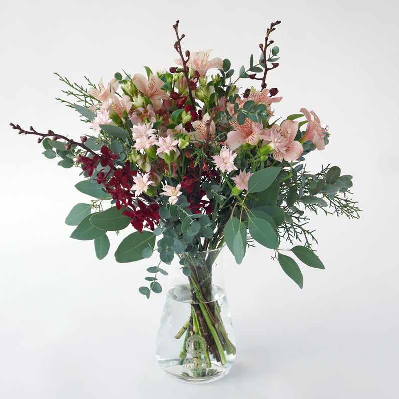 【クリスマス】ピンクや赤の花々に、季節感のあるリーフを合わせた花束
