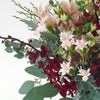 【クリスマス】ピンクや赤の花々に、季節感のあるリーフを合わせた花束